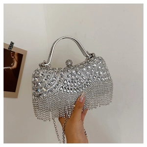 Detailed close-up of a silver rhinestone handbag with elegant tassels and metal handle