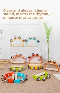 Close-up of colorful wooden semi-circle handbells with polished metal bells for infants