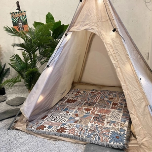 Bohemian style canvas play tent with wooden poles and printed floor mat for cozy indoor camping
