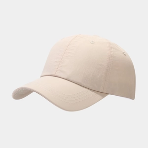 Detail of water-resistant ripstop nylon fabric and stitching on beige baseball cap