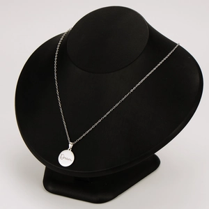Polished stainless steel round Dream pendant necklace displayed on a black neck bust