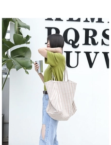 Detail of khaki checkered canvas tote bag with large capacity for daily casual use