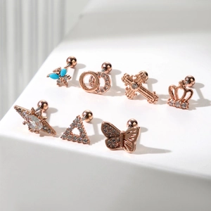 Set of 7 rose gold cartilage earrings with butterfly star and crown zircon designs