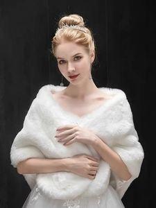 Detailed view of elegant white faux fur bridal shawl for autumn and winter weddings