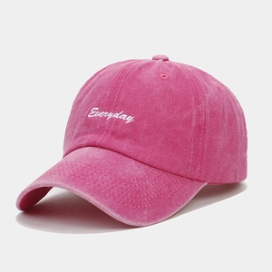 Close-up of vintage pink washed cotton baseball cap with white Everyday embroidery