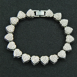 Detail of silver heart-shaped Cuban link chain necklace with sparkling rhinestones