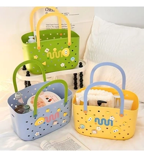 Three colorful plastic storage baskets with handles and cartoon pins on white bedding