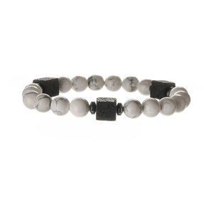 Macro shot of white marble pattern beads and black volcanic stones on beaded bracelet