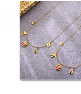 Detail of gold enamel Christmas jewelry set with gingerbread man and festive tree pendants