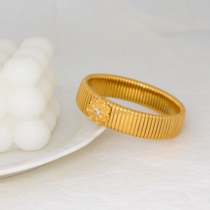 Macro detail of 18K gold plated flower bracelet with white zircon and flexible band