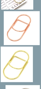Detaillierte Ansicht kreativer Metall-Stiftclips und Planer-Zubehör in Roségold und Gold.