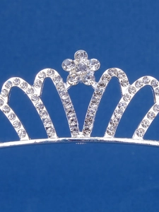 Close-up of silver crown headband with sparkling rhinestones and floral heart design
