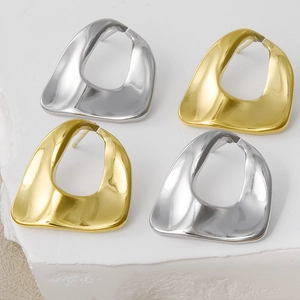 Detailed view of irregular geometric oval gold and silver stainless steel stud earrings