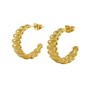 Golden C-shaped stainless steel hoop earrings with unique beaded bamboo texture