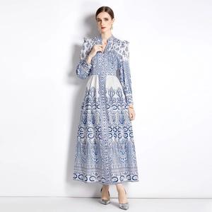 Elegant vintage V-neck maxi dress with blue floral prints and lantern sleeves on white background