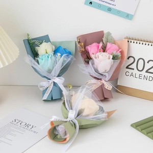 Soap rose bouquets in blue, pink, and champagne on a desk for holiday gift decor