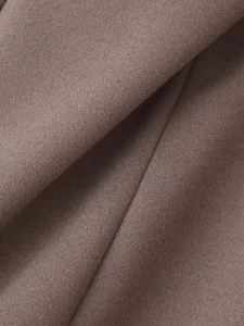 Makroaufnahme der hochwertigen bräunlichen Wollstofftextur dieses langen Einreiher-Mantels