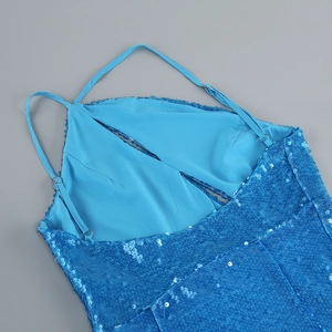Detail of blue sequin dress showing fine straps and shimmering fabric texture