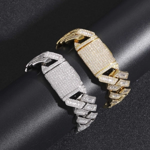 Detail of 20mm wide iced-out cuban link bracelets in gold and silver finishes