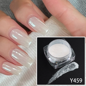 Macro shot of Y459 white pearl nail powder with aurora shimmer effect on long nails