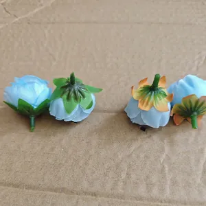 Blue rose fabric flower heads showing realistic petal detail and gradient green sepals