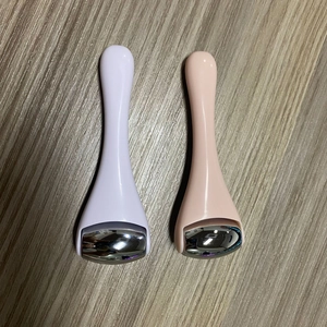 Dual mini alloy massage rollers for eye cream in light purple and nude pink with metal balls
