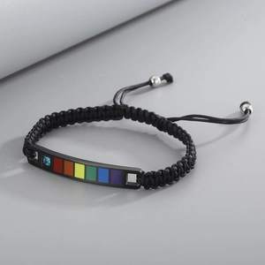 Detail of braided rainbow bracelet with black nylon cord and adjustable sliding knot