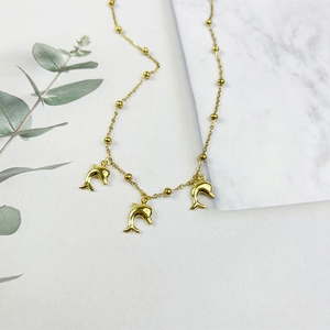 Gold-plated stainless steel necklace featuring dolphin pendants and beaded chain detail