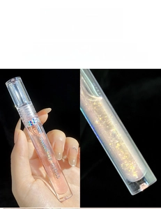 Macro detail of shimmer lip gloss in shade 04 Cherry Blossom with sparkling gold glitters