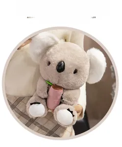 Close-up of soft grey plush koala holding pink bamboo with detailed claws and fur