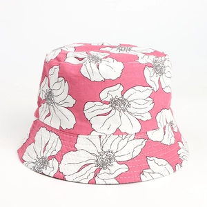 Close-up of pink bucket hat with white flower pattern and detailed stitching on the brim