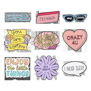 Detailed grid view of nine colorful enamel lapel pins with inspirational English slogans