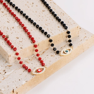 Handmade red and black crystal beaded necklaces featuring sparkling evil eye pendants