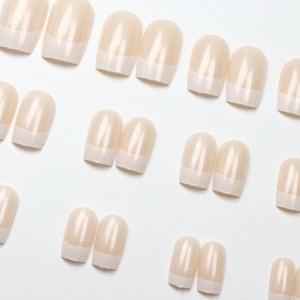Classic white French tip press-on nails in nude pink with a high-gloss finish