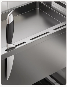 Detail of multi-slot knife holder and brushed metal surface on a kitchen spice rack