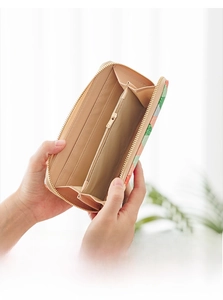 Interior detail of a long wallet featuring card slots, bill compartments and a zipper pocket