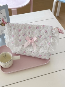 Floral quilted crossbody bag with lace edges and a pink satin bow decoration