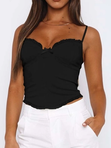 Detail of black Y2K camisole top featuring ruffled edges and delicate bow tie detail