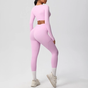 Pink yoga set showing long sleeve crop top and high-waisted leggings with side pockets