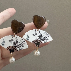 Detailed close-up of Neo-Chinese fan-shaped earrings with bamboo pattern and white pearl drop