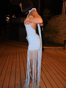 Side view of light blue halter backless dress featuring elegant long floor-length tassels