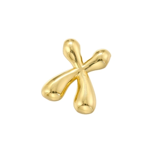 Macro view of gold bubble letter X charm with polished mirror finish and round edges