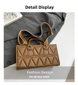 Detailed macro view of the brown quilted handbag with textured triangular stitching and gold metal hardware