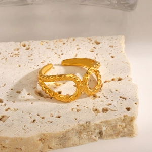 Chic gold-toned double-layered twisted rope ring with hammer texture on stone surface