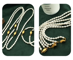 Detail of baroque pearl necklace with gold pebble accents on green velvet background