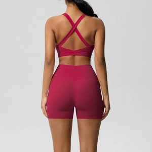 Back view of burgundy yoga set showing cross-back sports bra and high-waisted shorts