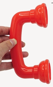 Close-up of a red plastic toy telephone handset being held against a white background