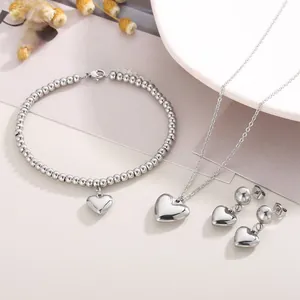 Polished silver heart jewelry set with beaded bracelet and matching pendant necklace