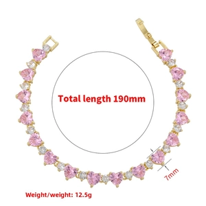 Detail view of 18K gold-plated bracelet with pink heart stones and clear zircon accents