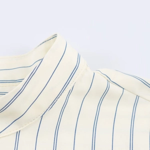 Close-up of the mandarin collar and fine stitching on this blue striped shirt
